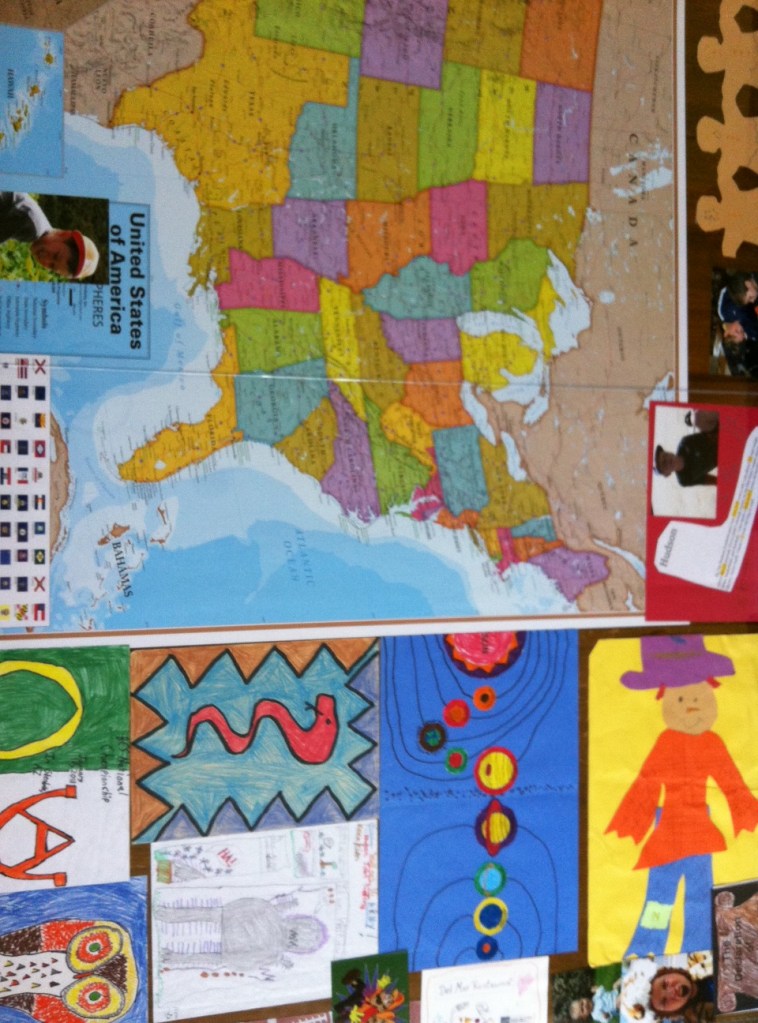  Looking down on the table from above . . . you see maps, art, and pictures.